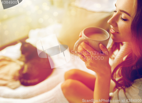 Image of close up of happy woman with cocoa cup at home