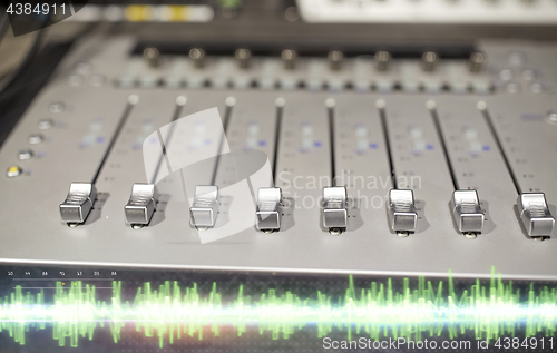 Image of music mixing console at sound recording studio