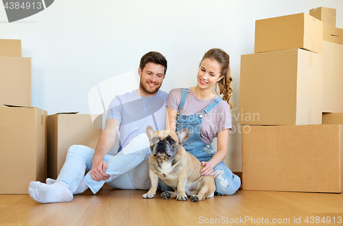 Image of happy couple with boxes and dog moving to new home