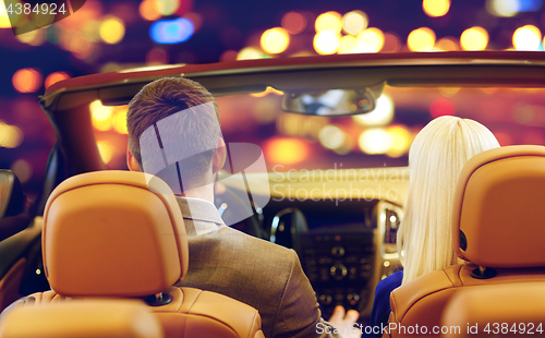 Image of close up of couple driving in convertible car