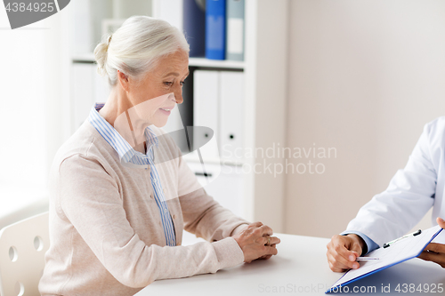 Image of senior woman and doctor meeting at hospital