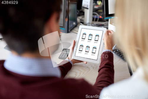 Image of web designers with user interface on tablet pc