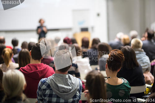 Image of Woman giving presentation in lecture hall at university.