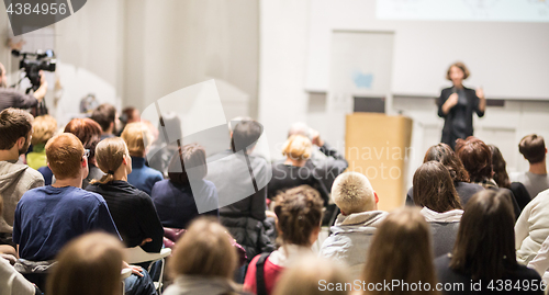 Image of Woman giving presentation in lecture hall at university.