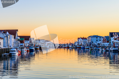 Image of fishing fleet berthed at sunset