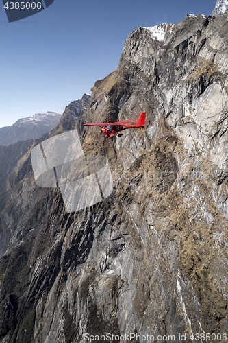 Image of Ultralight plane flies over Pokhara and Machapuchare