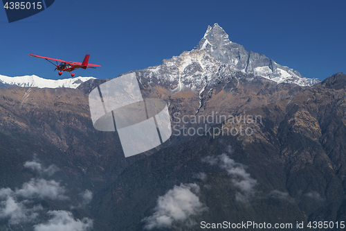 Image of Ultralight plane flies over Pokhara and Machapuchare