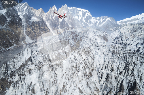 Image of Ultralight plane flies over Pokhara and Machapuchare