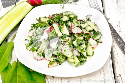 Image of Salad of radishes and sorrel with mayonnaise in plate on board