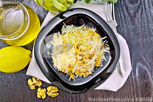 Image of Salad of carrot and kohlrabi with honey in plate on board top