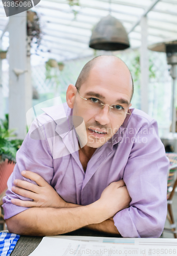 Image of Friendly Smiling Man Sitting On A Summer Terrace