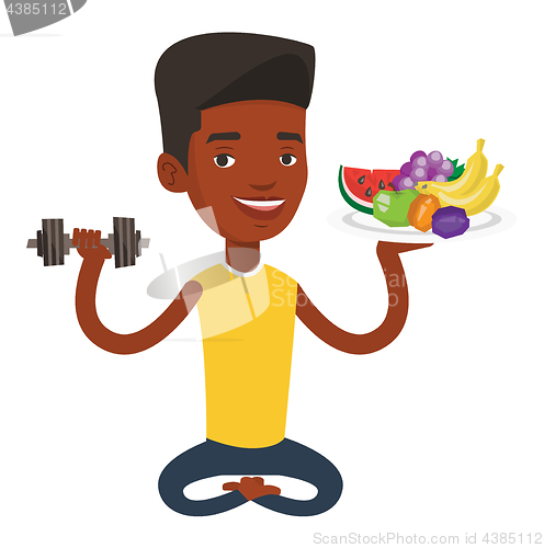 Image of Healthy man with fruits and dumbbell.