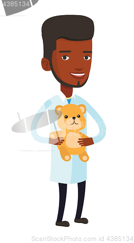 Image of Pediatrician doctor holding teddy bear.