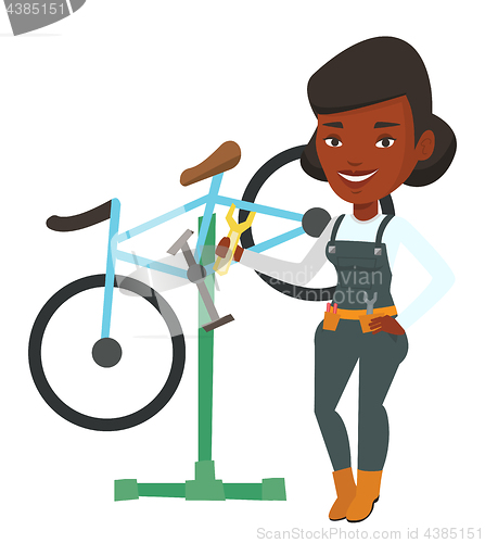 Image of African bicycle mechanic working in repair shop.