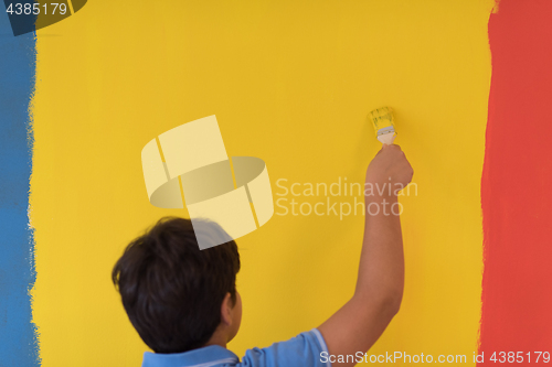 Image of Portrait of a happy young boy painter