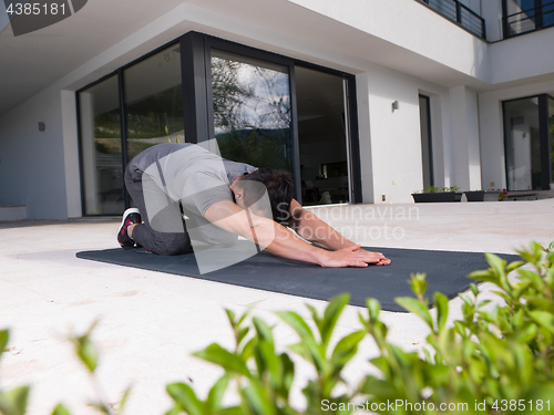 Image of man doing morning yoga exercises