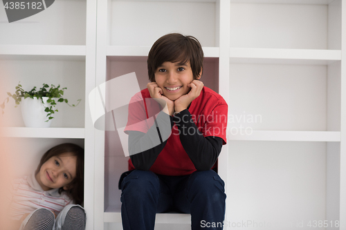 Image of young boys posing on a shelf