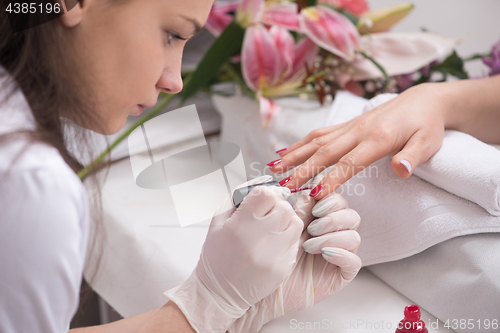 Image of Woman hands receiving a manicure