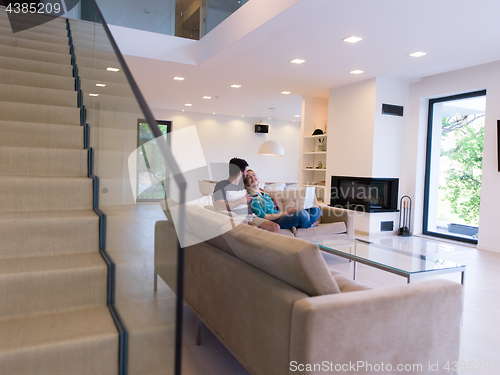 Image of young happy couple relaxes in the living room