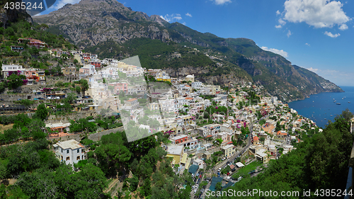 Image of One of the best resorts of Italy with old colorful villas on the steep slope, nice beach, numerous yachts and boats in harbor and medieval towers along the coast, Positano.