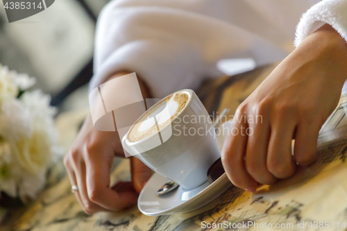 Image of Bride drinking coffee