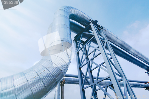 Image of Industrial zone, Steel pipelines and valves against blue sky