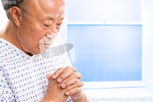 Image of Praying senior asian in hospital