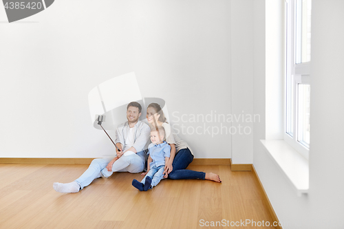 Image of family taking selfie by smartphone at new home