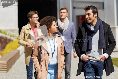Image of business team with conference badges in city