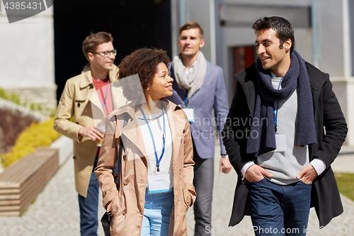 Image of business team with conference badges in city