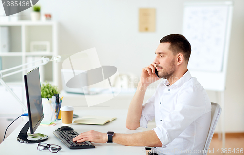 Image of businessman calling on smartphone at office