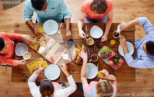 Image of group of people having breakfast at table