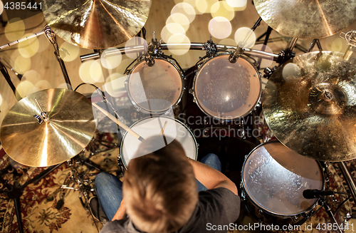 Image of musician or drummer playing drum kit at studio