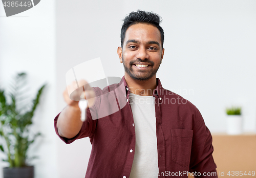 Image of happy man with key moving to new home