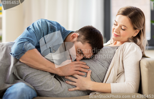 Image of happy man with pregnant woman at home