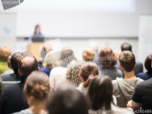 Image of Woman giving presentation in lecture hall at university.