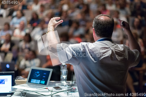 Image of Public speaker giving talk at Business Event.