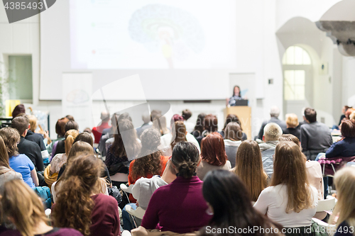 Image of Woman giving presentation in lecture hall at university.