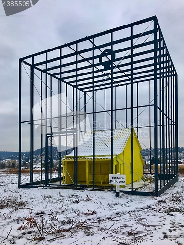 Image of Art Installation \"Das bedrohte Haus\" (The threatened house) by German artist Andreas Sarow