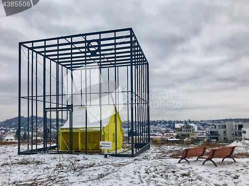 Image of Art Installation \"Das bedrohte Haus\" (The threatened house) by German artist Andreas Sarow