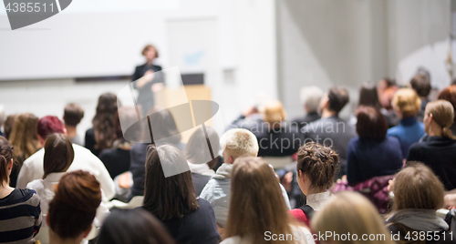 Image of Woman giving presentation in lecture hall at university.