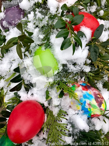 Image of Easter eggs and decoration in snow