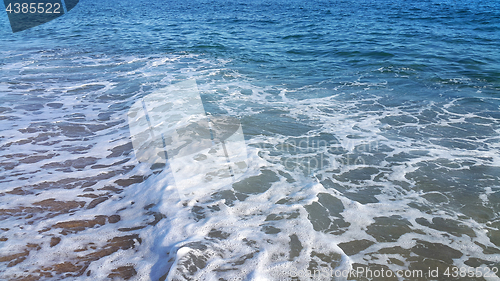 Image of Sea wave with white foam on the beach