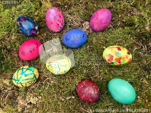 Image of Happy Easter - Colourful Easter eggs in green moss.