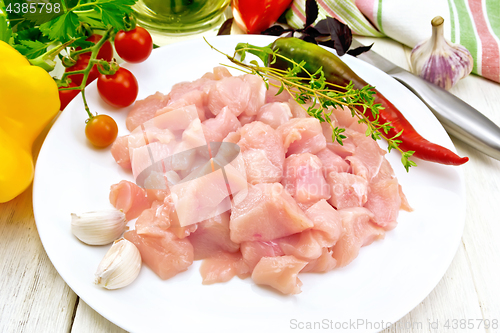 Image of Chicken breast raw sliced in plate on board