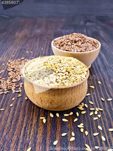 Image of Flaxen white and brown seed in bowl on dark board