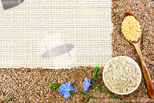 Image of Flour and flax seeds with flowers on coarse woven fabric