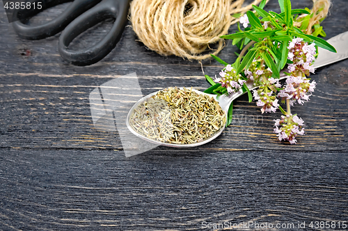 Image of Thyme dry in spoon with twine on board