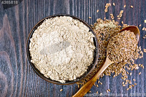 Image of Flour linen in bowl with seeds in spoon on board top