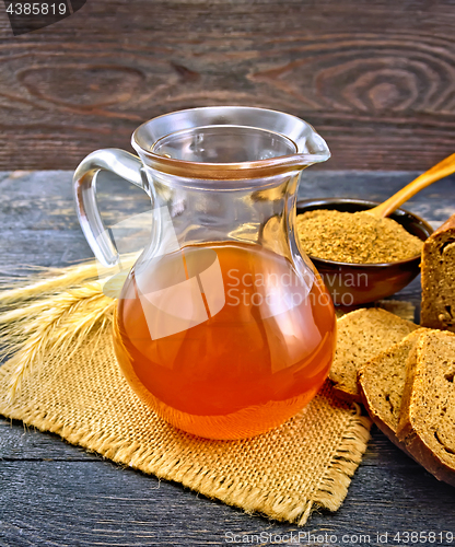 Image of Kvass in glass jug on board